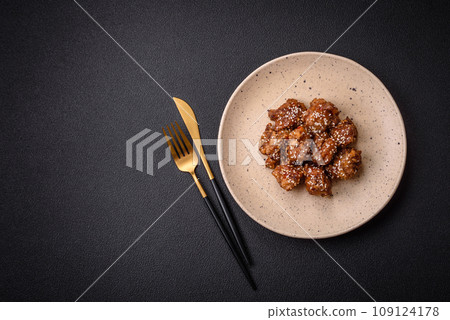 Delicious Asian dish with pieces of chicken in teriyaki sauce with salt and spices Delicious Asian dish with pieces of chicken in teriyaki sauce with salt and spices 109124178