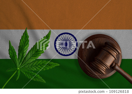 Justice wooden gavel with cannabis leaf on the Flag of India. Illegal growth of cannabis plant and drugs spreading Justice wooden gavel with cannabis leaf on the Flag of India. Illegal growth of cannabis plant and drugs spreading 109126818