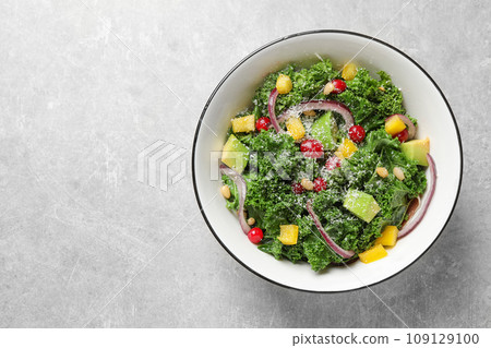 Tasty fresh kale salad on light grey table, top view Tasty fresh kale salad on light grey table, top view 109129100