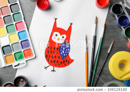 Flat lay composition with child's painting of owl on grey table Flat lay composition with child's painting of owl on grey table 109129180