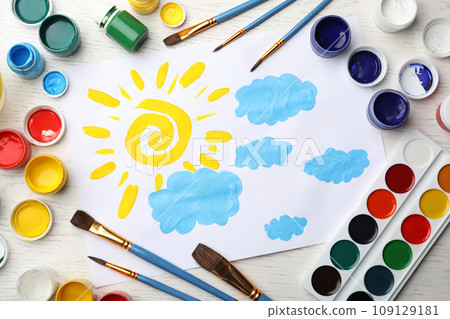 Flat lay composition with child's painting of sun and clouds on white wooden table Flat lay composition with child's painting of sun and clouds on white wooden table 109129181