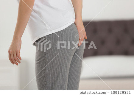 Young woman suffering from hemorrhoid at home, closeup 109129531