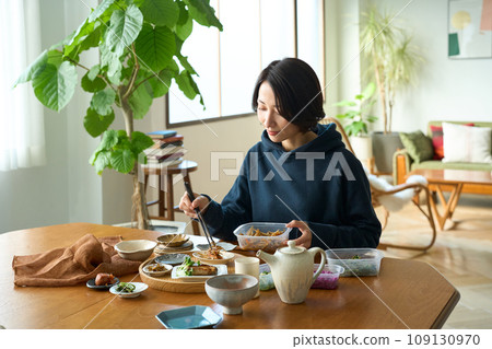 A woman serving prepared side dishes 109130970