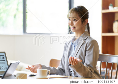 A business woman in a sales position giving an explanation A business woman in a sales position giving an explanation 109133107