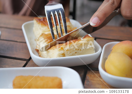 cutting Traditional Turkish Cuisine Pastries with knife cutting Traditional Turkish Cuisine Pastries with knife 109133178