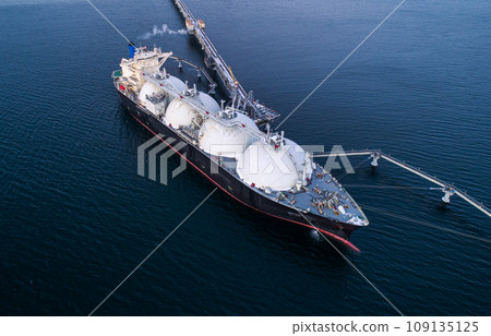 Aerial of Liquified Natural Gas LNG carrier moored to a small gas terminal. Fuel crisis. Sanctions 109135125