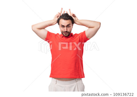 young brunette man with a beard is dressed in a red t-shirt with a mockup for printing on a white 109136722