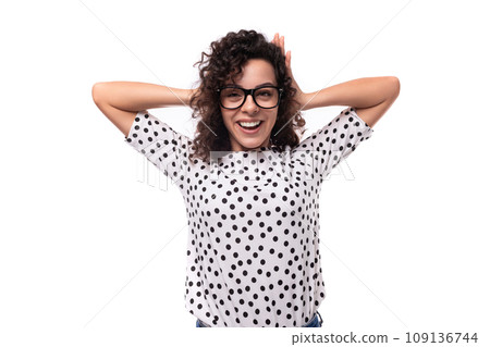 young authentic curly brunette slim lady wearing polka dot short sleeve shirt on white background 109136744