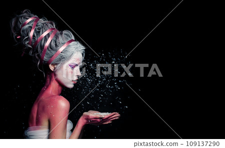Beautiful model woman with creative makeup and white snow on black background Beautiful model woman with creative makeup and white snow on black background 109137290