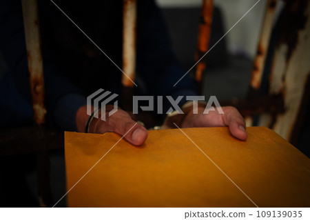 Asian businessmen hold documents and wear handcuffs in jail after arrest because corruption and defrauding insurance. Concept of punishment for crime fraudulent, victim criminal, justice protection. Asian businessmen hold documents and wear handcuffs in jail after arrest because corruption and defrauding insurance. Concept of punishment for crime fraudulent, victim criminal, justice protection. 109139035