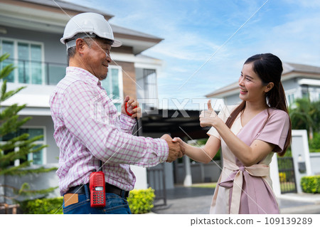 Happy homeowner stand in front of contractor and shake hand, handyman holding clipboard and after checking details before renovations home, house improvement interior, Interior design Happy homeowner stand in front of contractor and shake hand, handyman holding clipboard and after checking details before renovations home, house improvement interior, Interior design 109139289