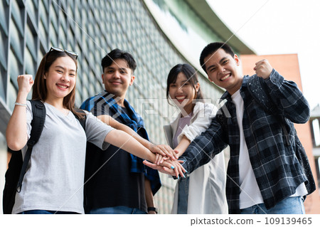 Group of cheerful young Asian entrepreneurs joining hands together to celebrate, excited success for achievements obtained. Undergraduate students celebrate success after end project, teamwork concept Group of cheerful young Asian entrepreneurs joining hands together to celebrate, excited success for achievements obtained. Undergraduate students celebrate success after end project, teamwork concept 109139465