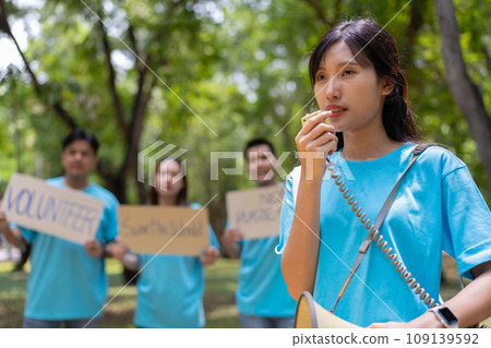 Happy young Asian students diverse volunteers hold a campaign sign for cleaning in the park, The concept of environmental conservation on world environment day, recycling, charity for sustainability. Happy young Asian students diverse volunteers hold a campaign sign for cleaning in the park, The concept of environmental conservation on world environment day, recycling, charity for sustainability. 109139592