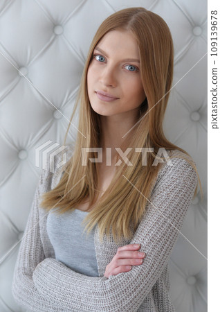 Beauty portrait. Young woman on grey wall background. 109139678
