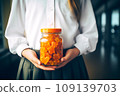 Schoolgirl child holds in her hands a jar of chewable gummy vitamins. The concept of taking vitamins to keep the child healthy while studying 109139703