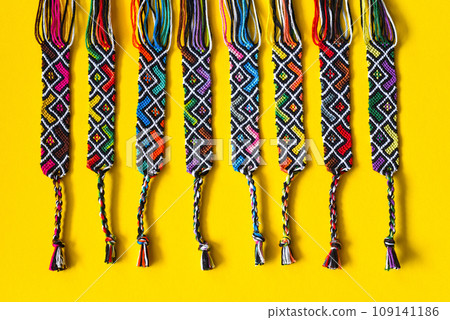 Unfinished DIY woven friendship bracelets with abstract geometric pattern. Summer accessories 109141186