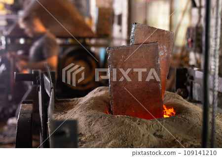 Foundry - ferrous metal is melted in an induction furnace of metallurgical plant 109141210