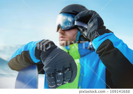 Close Up Of The Ski Goggles Of A Man With The Reflection Of Snowed Mountains. Man In The Background Blue Sky.  Winter Sports. 109141688