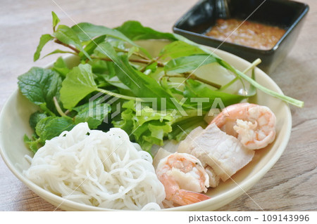 rice noodles with boiled shrimp and slice pork belly eat couple variety vegetable salad dressing chili sauce on plate rice noodles with boiled shrimp and slice pork belly eat couple variety vegetable salad dressing chili sauce on plate 109143996