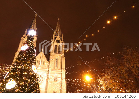 Christmas market in front of the church at night 109144200
