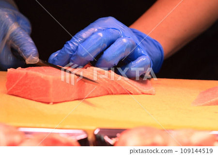 Hands of chef preparing ingredients for nigiri sushi Hand of craftsman preparing tuna 109144519