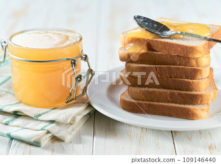 Delicious ginger jam on table close-up. Bread and ginger homemade jam on wooden table. 109146440