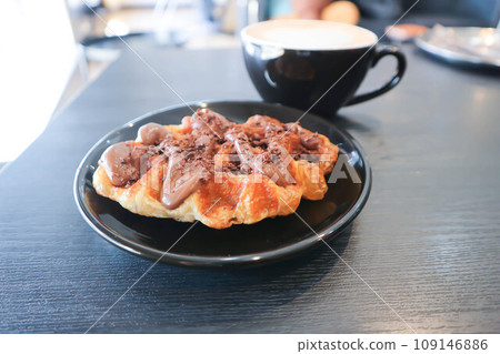 chocolate waffle or waffle with chocolate topping and coffee 109146886