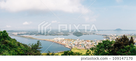 Panoramic view of sea and city from Seongsan Ilchulbong Tuff Cone in Jeju Island, Korea Panoramic view of sea and city from Seongsan Ilchulbong Tuff Cone in Jeju Island, Korea 109147170