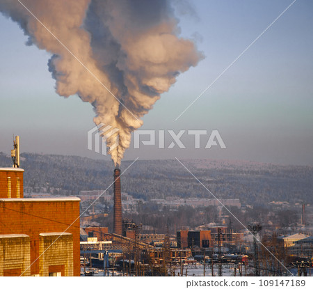Plume of thick smoke from the pipe of an industrial heat station in the frosty Siberian air. Plume of thick smoke from the pipe of an industrial heat station in the frosty Siberian air. 109147189