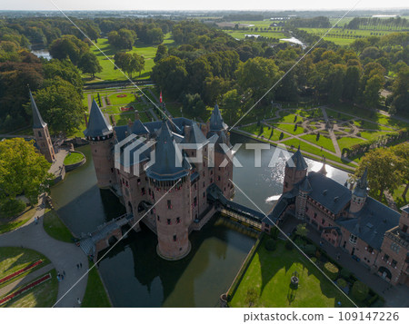 Top view of the largest castle in the Netherlands, De Haar. A beautiful quadcopter flight over the castle, the park and the water moat around the castle. A beautiful park in English style. Top view of the largest castle in the Netherlands, De Haar. A beautiful quadcopter flight over the castle, the park and the water moat around the castle. A beautiful park in English style. 109147226