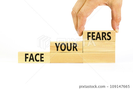 Face your fears and support symbol. Concept words Face your fears on wooden blocks. Businessman hand. Beautiful white table white background. Business and Face your fears quote concept. Copy space. 109147665