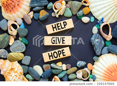 Help give hope symbol. Concept word Help give hope on beautiful wooden block. Sea shell stone. Beautiful black table black background. Business motivational help give hope concept. Copy space. 109147669