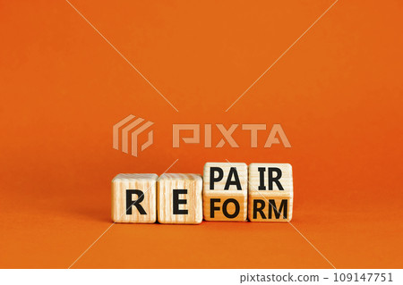 Reform and repair symbol. Concept words Reform Repair on wooden block. Beautiful orange table orange background. Business reform and repair concept. Copy space. 109147751