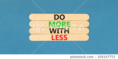 Do more with less symbol. Concept word Do more with less on beautiful beautiful wooden stick. Beautiful blue table blue background. Business do more with less concept. Copy space. Do more with less symbol. Concept word Do more with less on beautiful beautiful wooden stick. Beautiful blue table blue background. Business do more with less concept. Copy space. 109147753