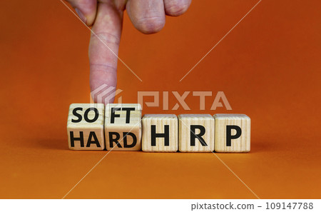 HRP, human resource planning symbol. Businessman turns wooden cubes and changes words hard HRP to soft HRP. Beautiful orange background. Business, HRP, human resource planning concept. Copy space. HRP, human resource planning symbol. Businessman turns wooden cubes and changes words hard HRP to soft HRP. Beautiful orange background. Business, HRP, human resource planning concept. Copy space. 109147788