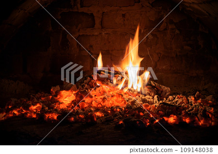 Logs of firewood burn out in the oven. Coals and flames in the fireplace. Logs of firewood burn out in the oven. Coals and flames in the fireplace. 109148038
