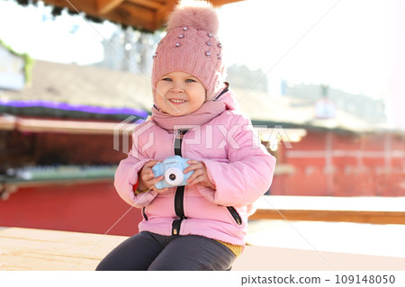 Cute little photographer with toy camera outdoors 109148050