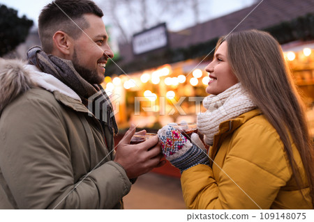 Happy couple with mulled wine at winter fair Happy couple with mulled wine at winter fair 109148075