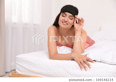 Beautiful woman wearing sleeping mask at home. Bedtime 109148214