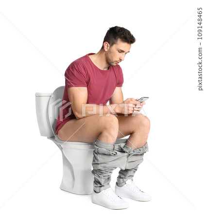 Man with smartphone sitting on toilet bowl, white background 109148465