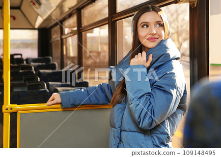 Woman listening to audiobook in trolley bus 109148495