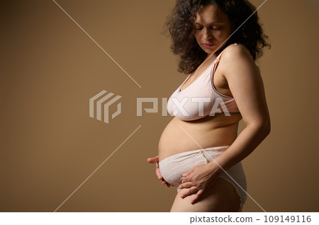 Body positive woman mother in lingerie, with postnatal naked belly with flaws stretch marks few days after childbirth Body positive woman mother in lingerie, with postnatal naked belly with flaws stretch marks few days after childbirth 109149116