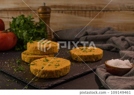 Raw veggie burger with chickpeas and vegetables Raw veggie burger with chickpeas and vegetables 109149461