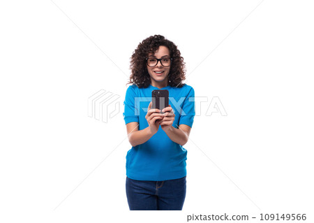 young curly woman with black hair is dressed in a blue corporate t-shirt and takes a photo on the 109149566
