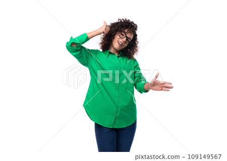 well-groomed young marketing employee woman in glasses is dressed in a green blouse and jeans 109149567