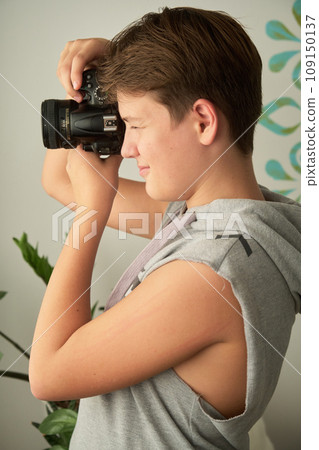 a boy with camera in his hands 109150137