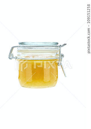 front view of small lemon jam jar without labels and shiny metallic lid covers isolated on white background. 109151258