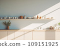 Interior of modern minimalist Scandi style kitchen. White facades, open shelves with utensils and dinnerware, wooden countertop, home appliances, beautiful light from window. Contemporary home design. 109151925