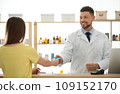 Pharmacist giving medicine to customer in drugstore 109152170
