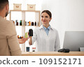 Pharmacist giving medicine to customer in drugstore 109152171
